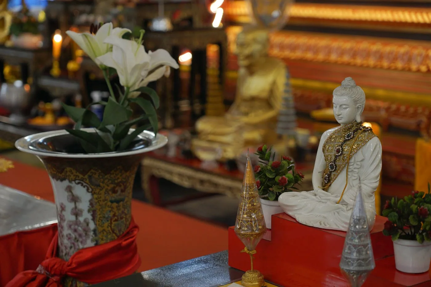 Soka Gakkai-style Buddhist altar with white lily and lit candles