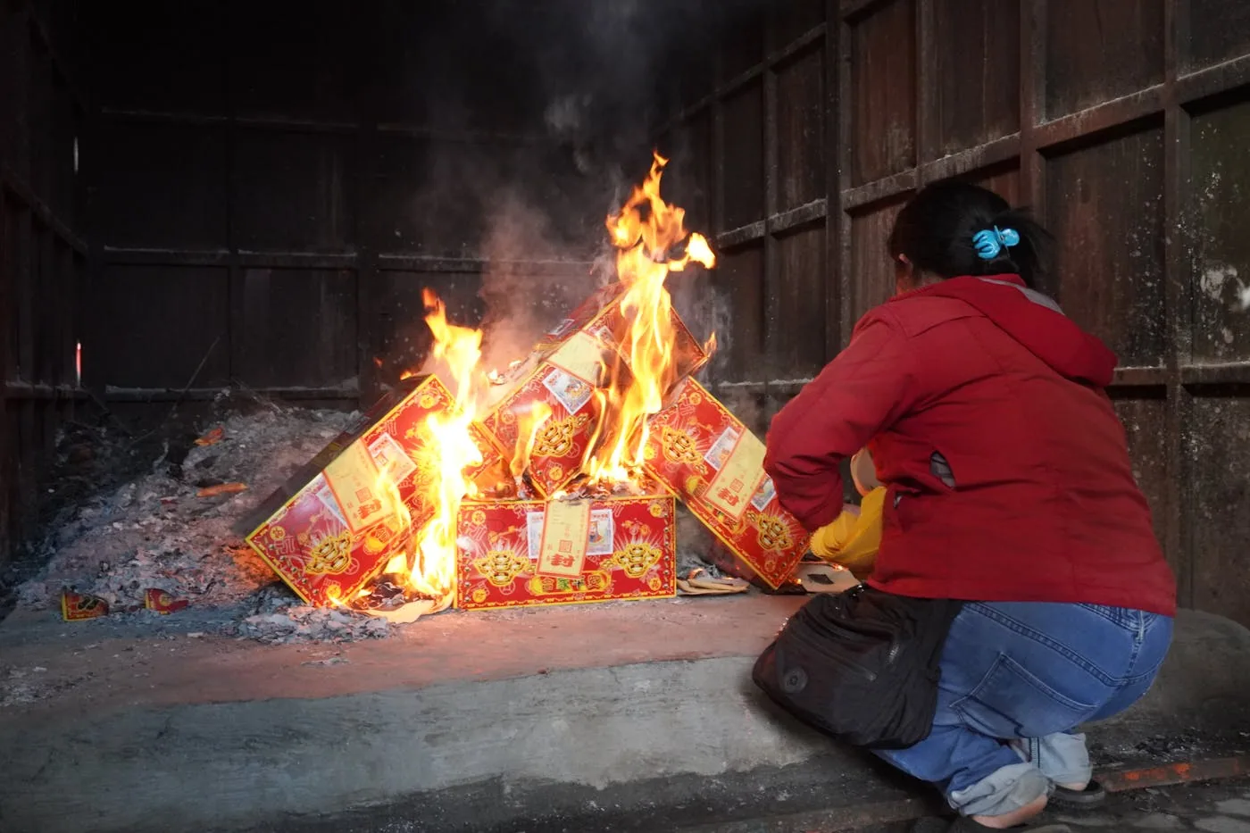 Traditional Chinese joss paper offerings burning at a Taoist ritual